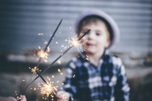 Ignite Faith Niagara young boy lighting a sparkler.