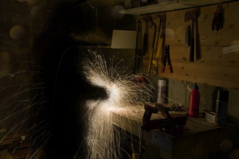 Ignite Faith Niagara man working on lathe in workshop sparks flying