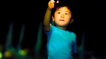 Young Asian boy holding a sparkler representing Ignite Faith Niagara