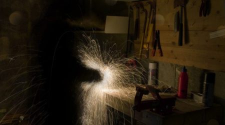 Ignite Faith Niagara man working on lathe in workshop sparks flying